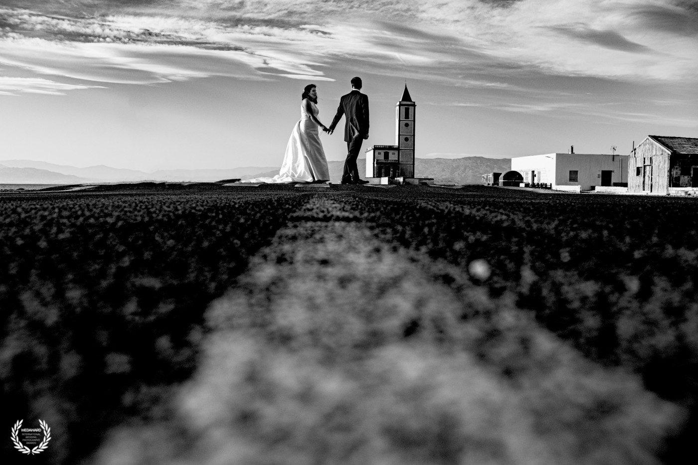 Fotografía en blanco y negro de una pareja caminando sobre la carretera