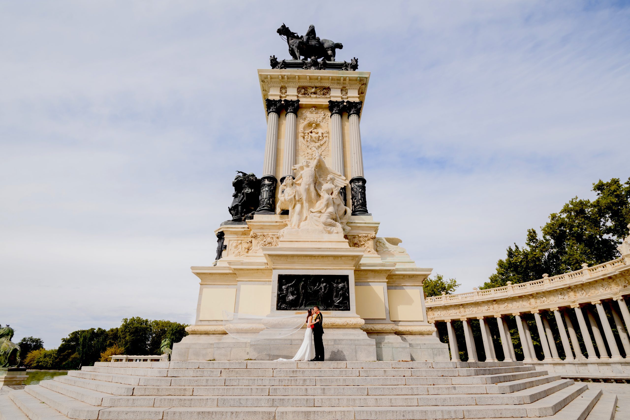 Fotografía de una pareja al lado de un monumento
