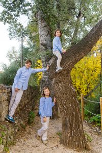 ninos jugando en un arbol en un camino de naturaleza
